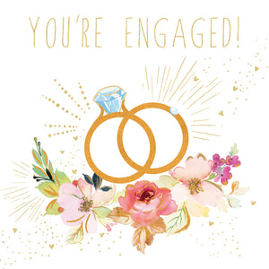 Engagement card with two interlocking rings, flowers, and 'You're Engaged!' text on a white background.